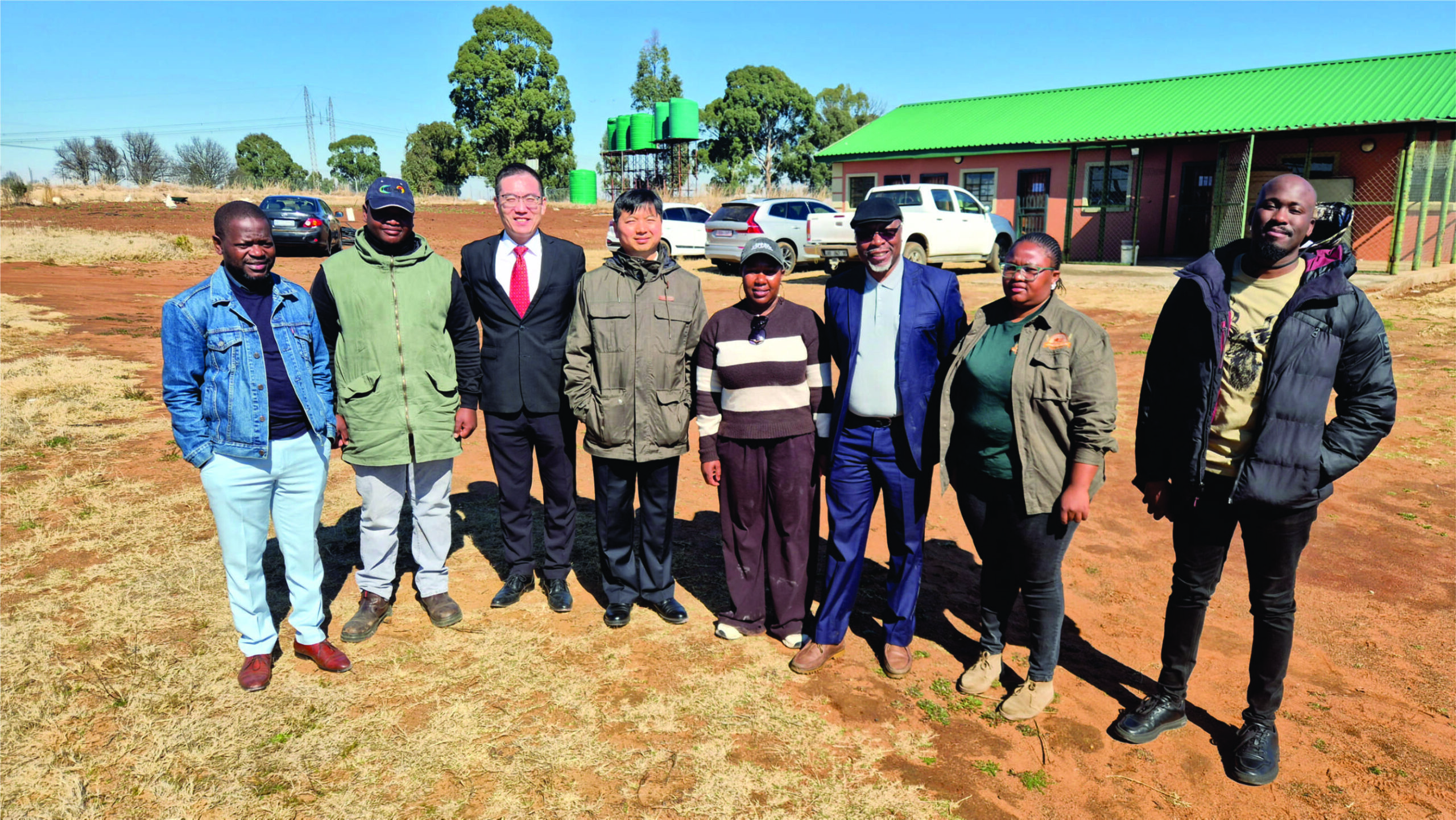 L-R Dr, Gideon Chitanga, Mr Zhu Liang, Deputy Director of the Press Section (Red Tie), Mr Zhou Bin, First Secretary of the Commercial Section, Mr. Austin Moyo (Navy Suite) with the founding Directors of Optimist Agri Farming during a live tour before the seminar to their piggery